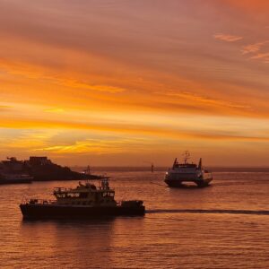 Poswer driven vessels at sunset