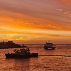 Poswer driven vessels at sunset